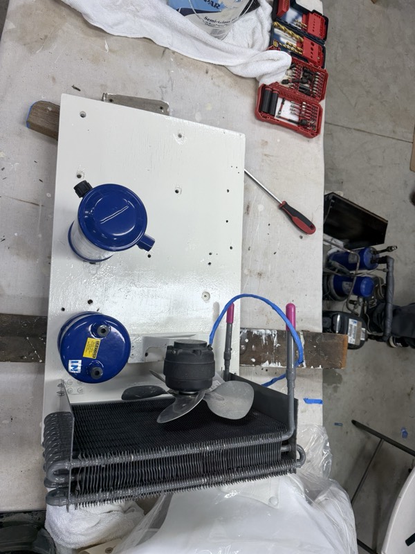 Condenser, fan and refrigerant vessels laid out on the board