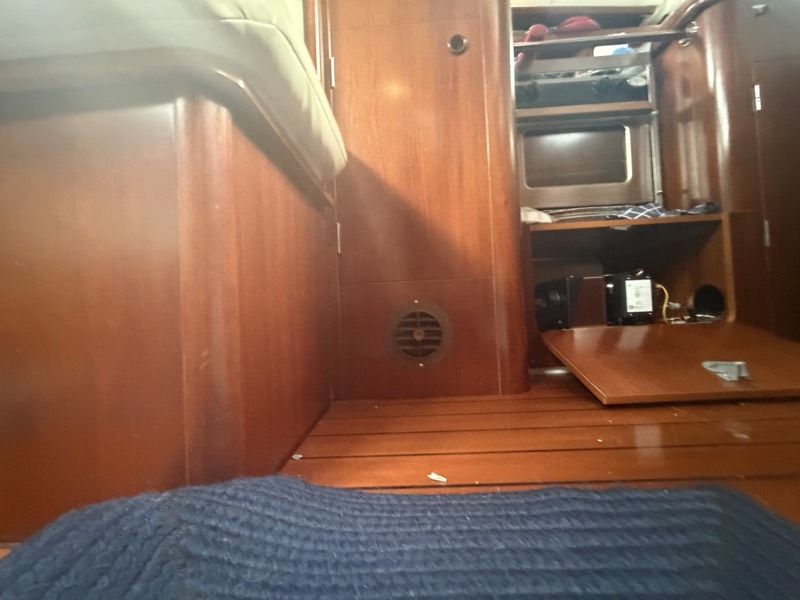 Galley access panel open to the refrigeration unit beneath