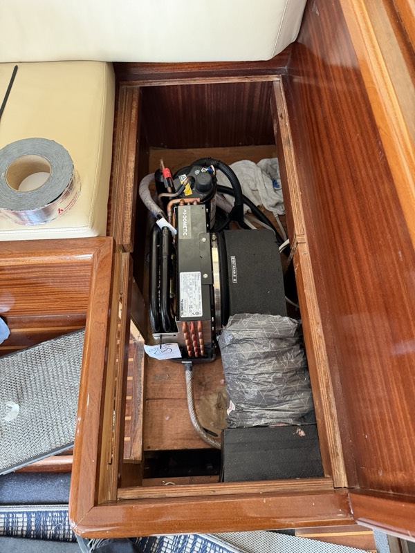 Air conditioning unit beneath a settee