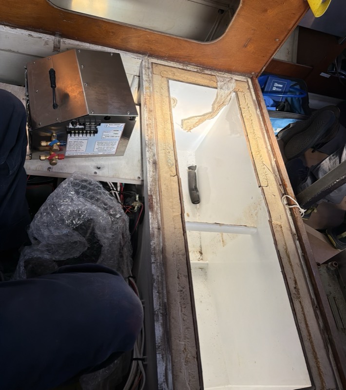 Freezer box opened up, with the refrigeration unit alongside