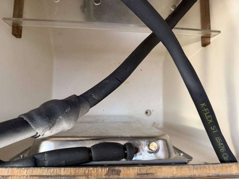 Holding plate with insulated refrigerant lines