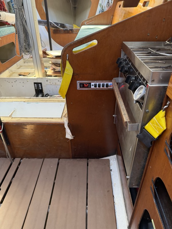 Control panel mounted on the bulkhead beside the galley stove
